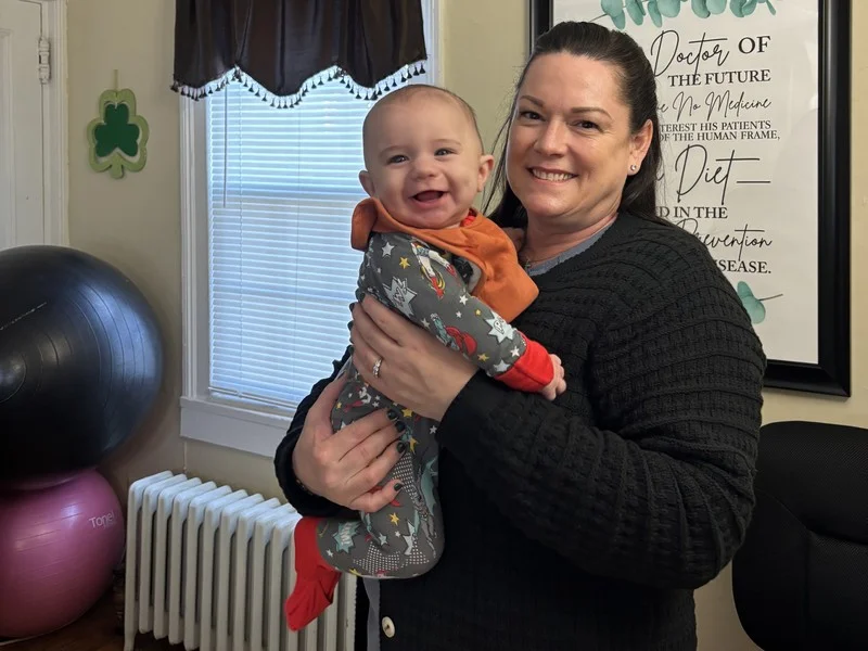 Dr. Desiree Curley caring for a young patient at Essential Life Chiropractic