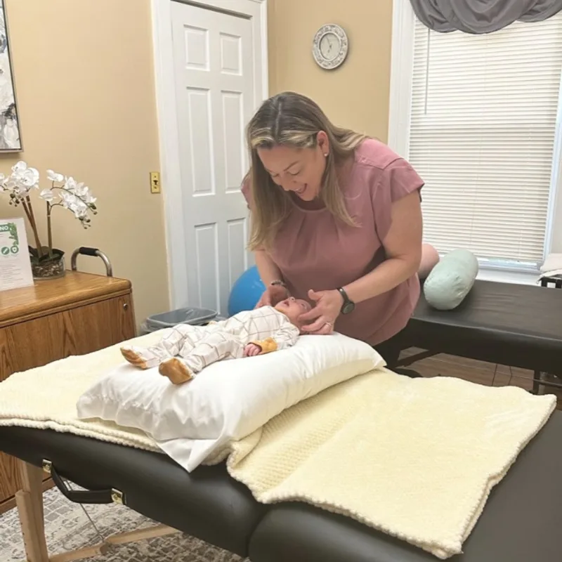 Dr. Desiree Curley providing gentle pediatric chiropractic care at Essential Life Chiropractic in Freehold