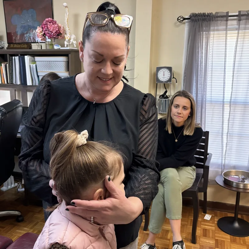 Dr. Desiree Curley providing gentle pediatric chiropractic care at Essential Life Chiropractic in Freehold