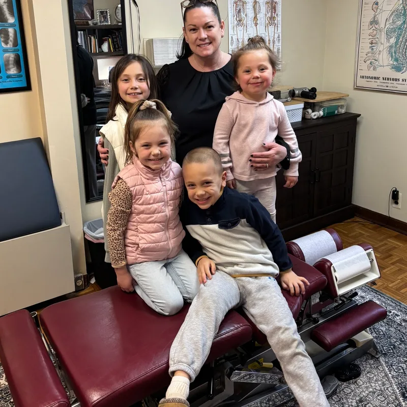 Dr. Desiree Curley providing gentle pediatric chiropractic care at Essential Life Chiropractic in Freehold