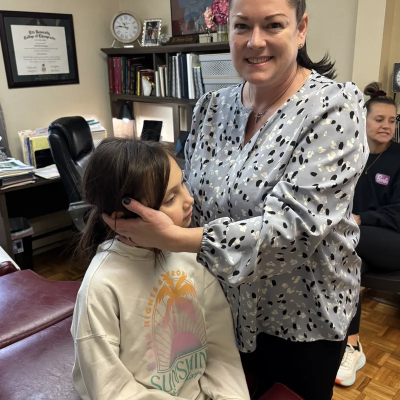 Dr. Desiree Curley providing gentle pediatric chiropractic care at Essential Life Chiropractic in Freehold