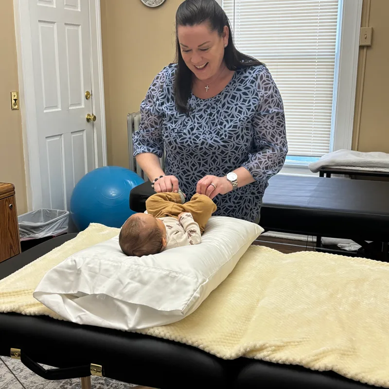 Dr. Desiree Curley providing gentle pediatric chiropractic care at Essential Life Chiropractic in Freehold